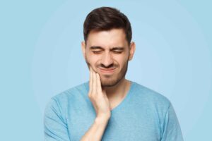 Man suffering from a toothache and oral discomfort.