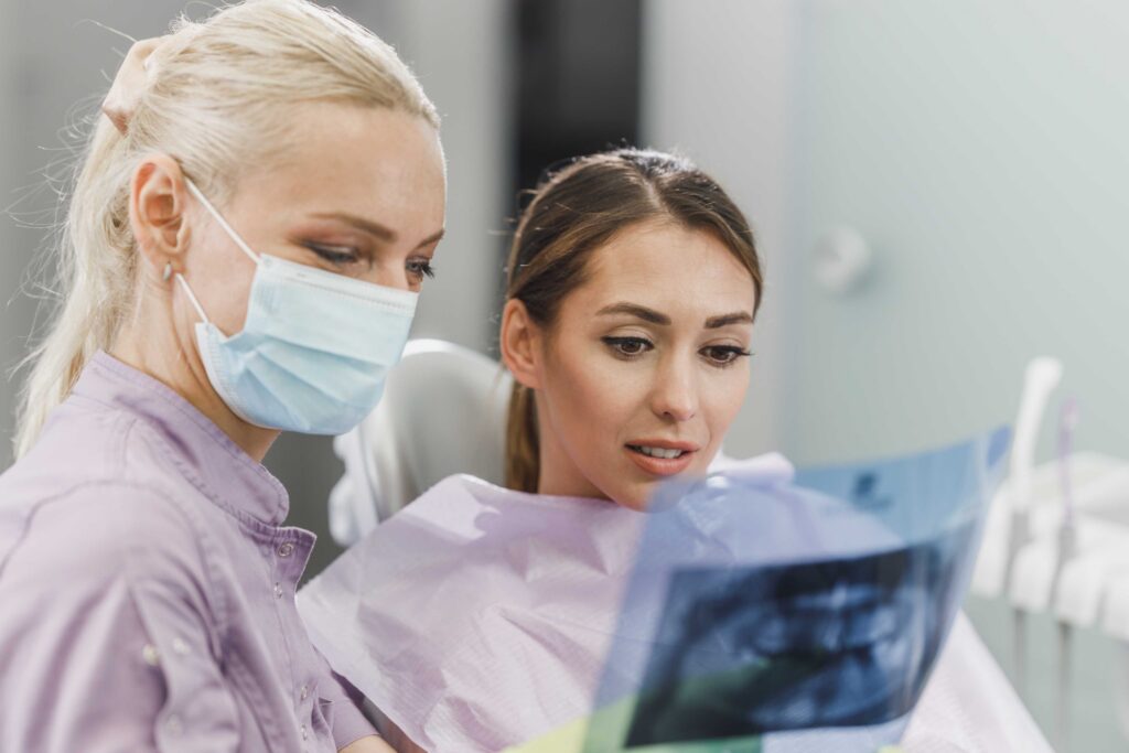 Dentist explaining a dental X-ray to a patient
