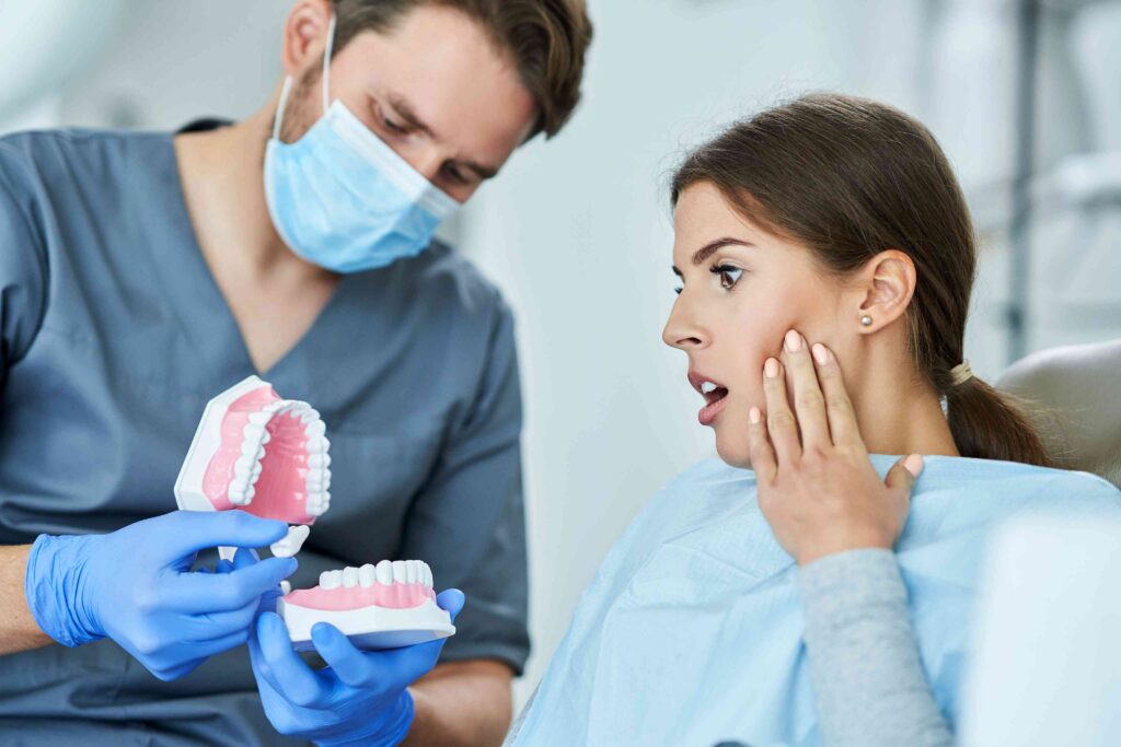 Dentist showing a denture to a patient during a dental consultation