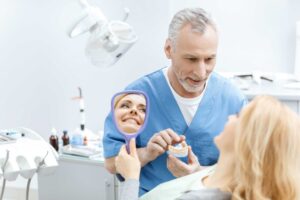 Patient reviewing dental veneers with a dentist.