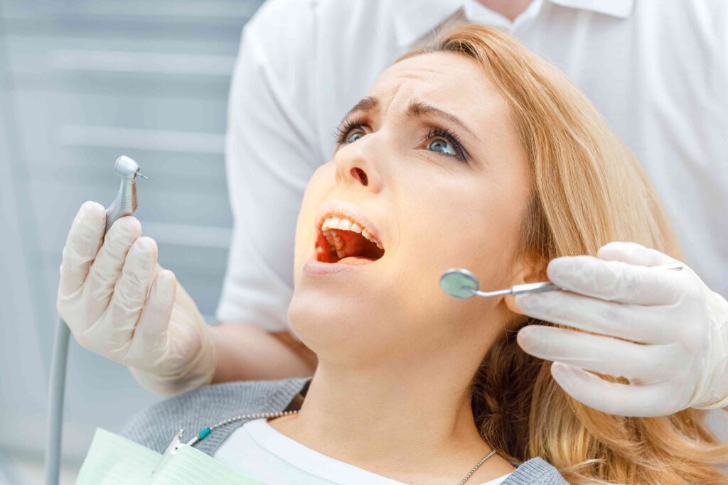 Nervous patient receiving reassurance before dental treatment.