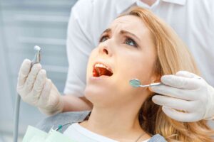 Nervous patient receiving reassurance before dental treatment.