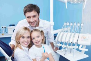 Family visiting a dental clinic with child.