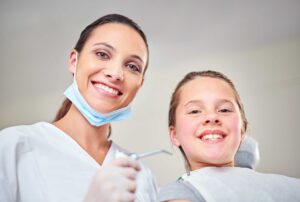 Dentist with smiling young patient